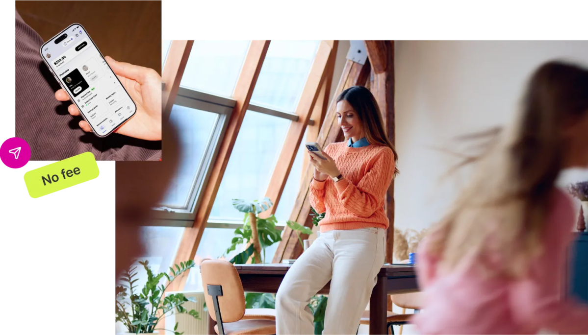 Person in orange sweater checking a banking app with no monthly fee on smartphone, showing $258.00 balance in a bright sunlit room.