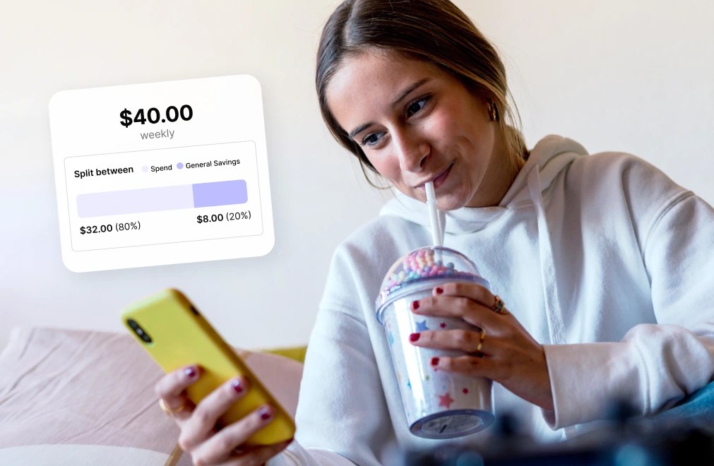 A teen siting on a sofa tracking her saving and spend balance in the Mydoh app